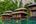 a group of houses on a dock in a body of water