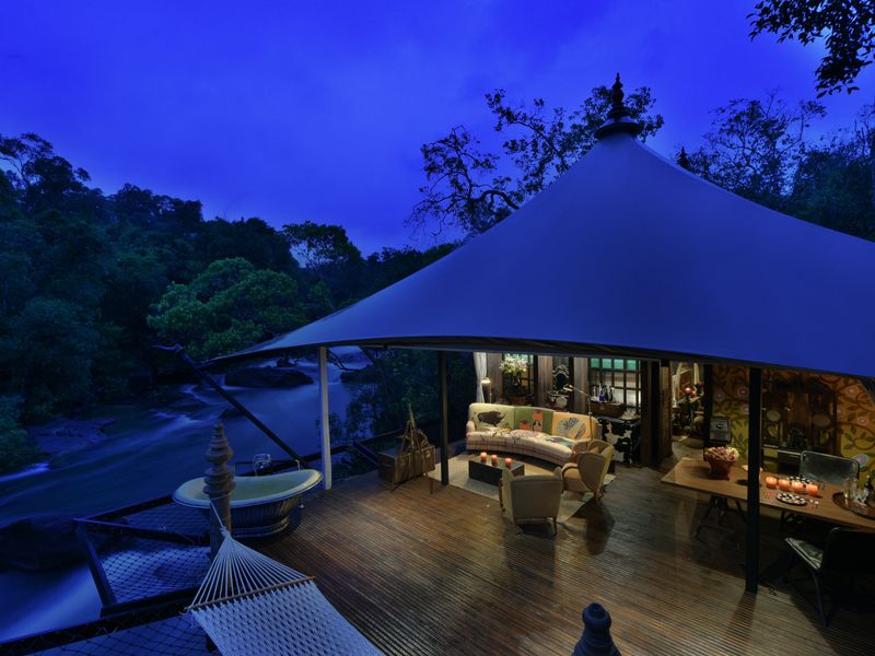 Veranda at night with bath at Shinta Mani Wild