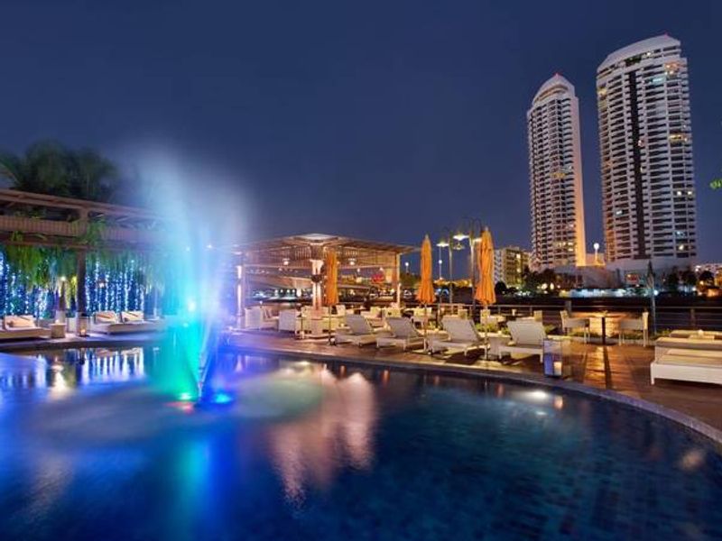 Pool at night overlooking Bangkok at Riva Surya