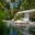 a pool with lounge chairs and trees