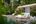 a pool with lounge chairs and trees