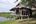 a wooden house on stilts by water