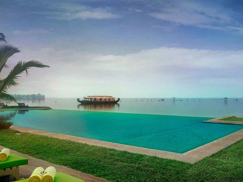 Pool next to lake at Kumarakom Lake Resort