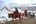 a group of people riding horses in the snow