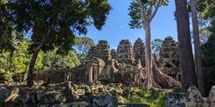 a stone building with trees in the background