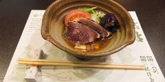 Bowl of food with chopsticks