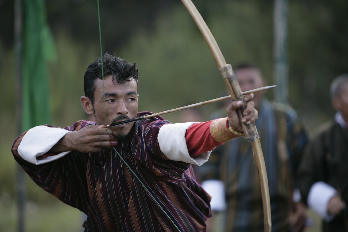 Man performing Bhutanese archery