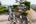 a man standing next to bicycles