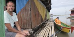 a man sitting on a dock