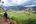 a man standing on a hill looking at a landscape