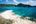 a beach with a sandy beach and blue water