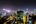 a city at night with many tall buildings