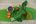a green fruit and vegetables on a banana leaf