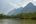a river with trees and mountains in the background