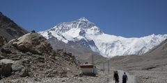 a couple of people walking on a road