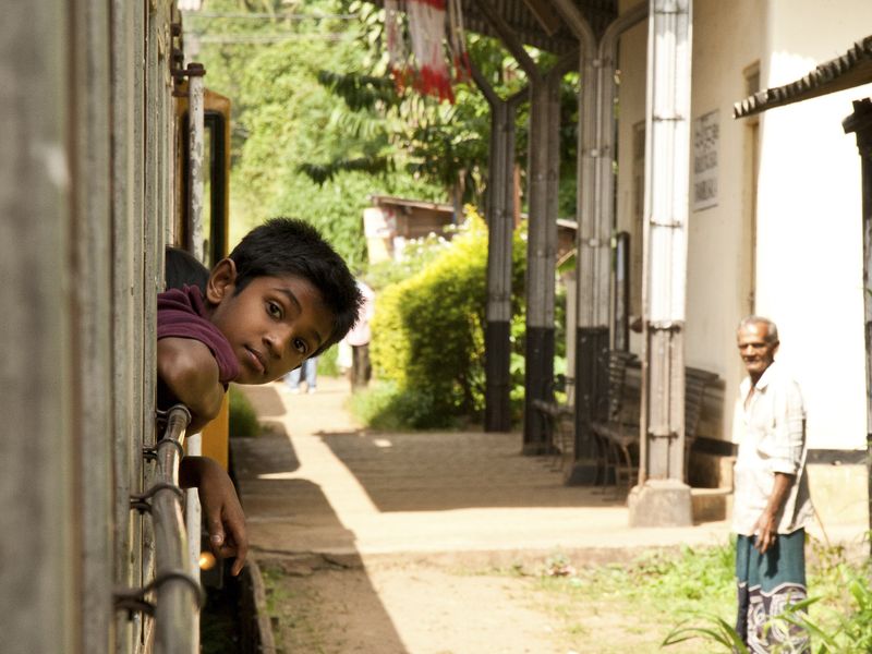 Boy leaning out of window on train