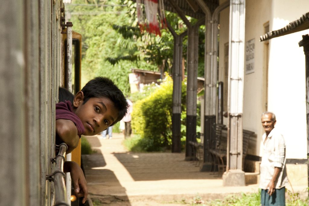 Boy leaning out of window on train