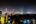 a city at night with trees