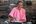 a woman in a pink shirt making food