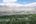 a city with trees and mountains in the background