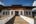 a white building with a wooden walkway