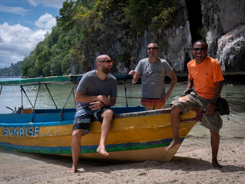 People laughing on a beach in Asia