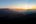 a sun setting over a valley