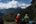 a couple of people sitting on a mountain