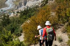 a couple of people hiking in the mountains
