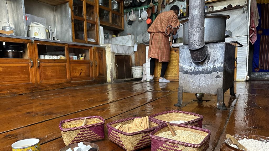 Man washing up at a sink with baskets in foreground