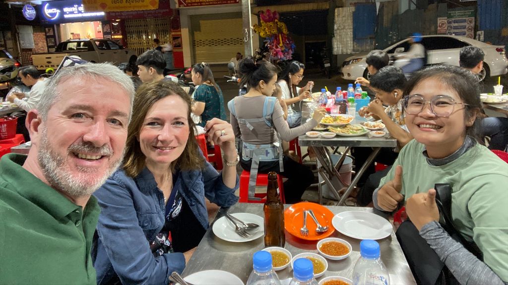 Customers eating with guide in Cambodia