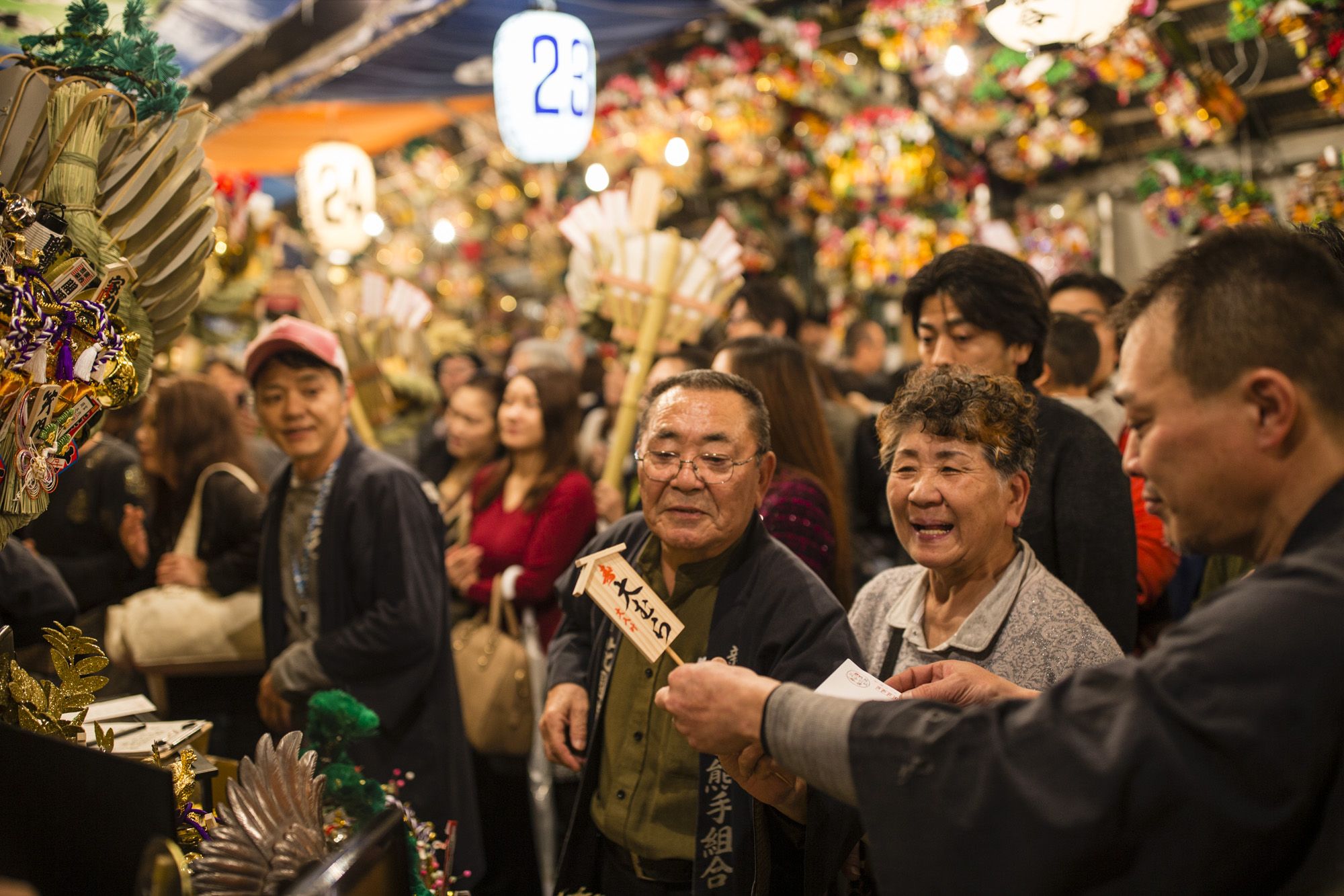 Customers at a stall at Torinoichi festival Shinjuku Tokyo Japan