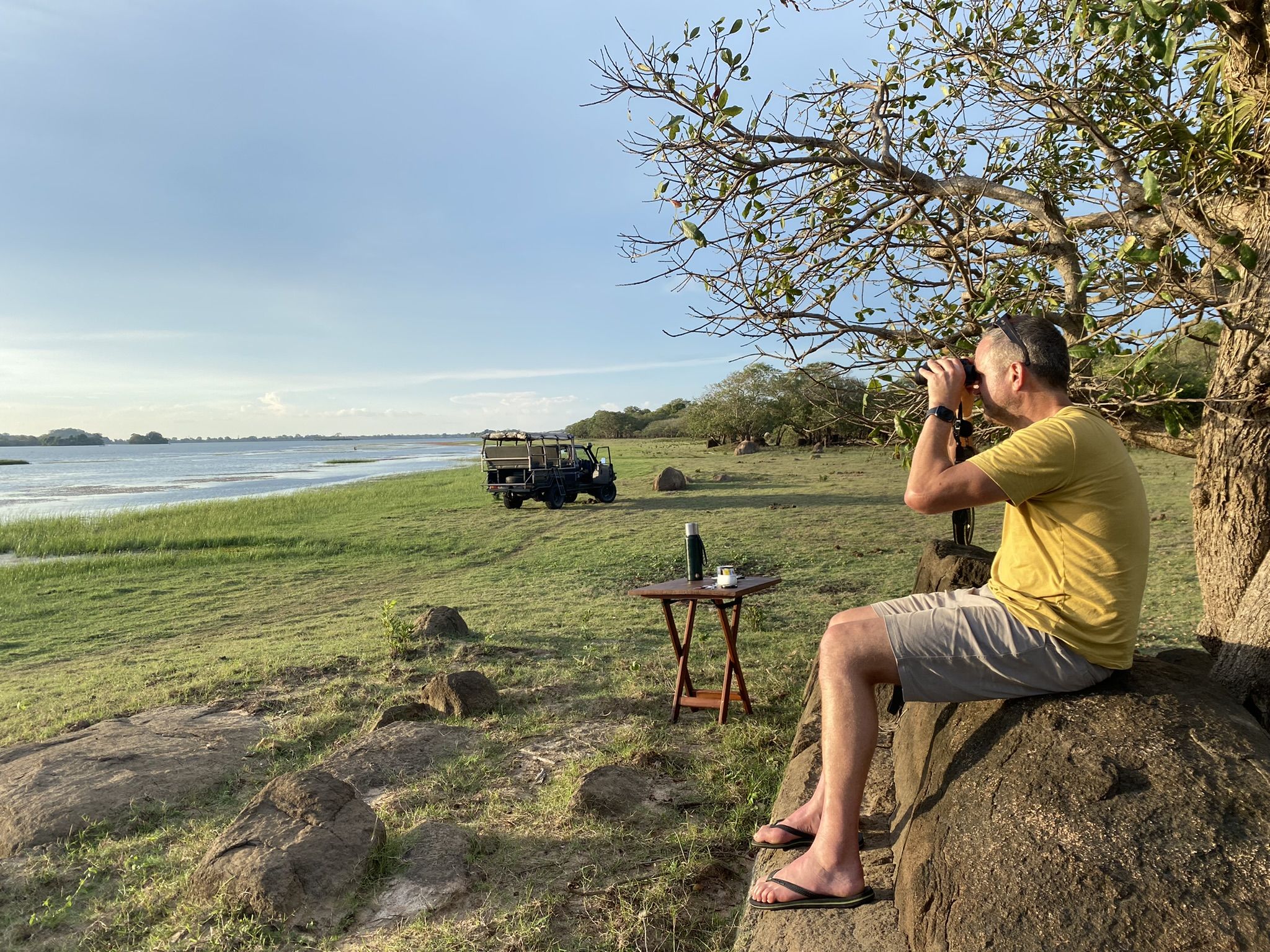 Man looking through binoculars in Wasgamuwa National Park
