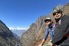 a group of men sitting on a mountain