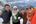 a group of people standing on a snowy mountain
