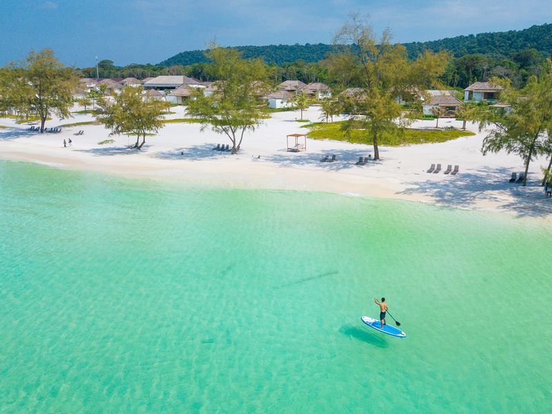 Paddle boarding on turquoise sea at Royal Sands