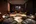 a room with black chairs and a television
