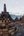 a group of stone pagodas with Borobudur in the background