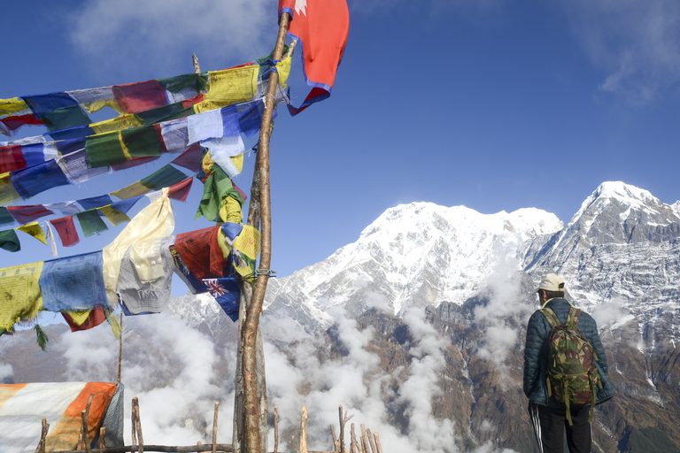 a man standing in front of a mountain
