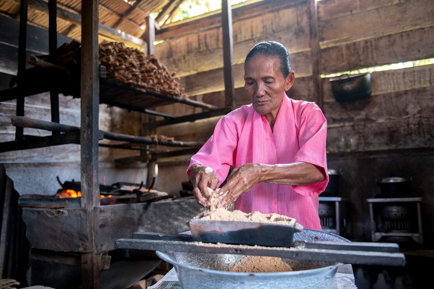 Woman cooking in wooden hut Indonesia