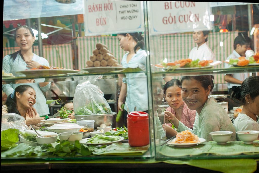 girls laughing on cafe window in ho chi minh city