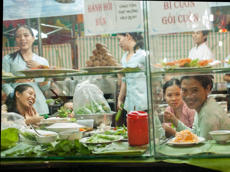 girls laughing on cafe window in ho chi minh city