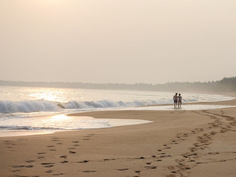 Couple walking on a beach in Sri Lanka