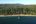 a dock on a beach surrounded by trees
