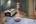 a room with a massage table and a bed