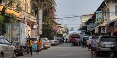 a street with cars and people on it