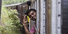 a man waving from a train window