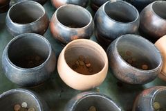a group of pots with coins in them