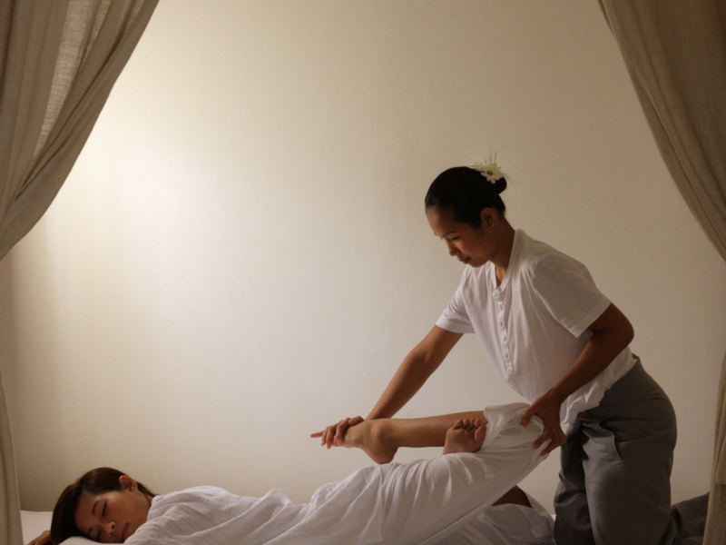 Woman having Thai massage at Como Metropolitan Bangkok Spa